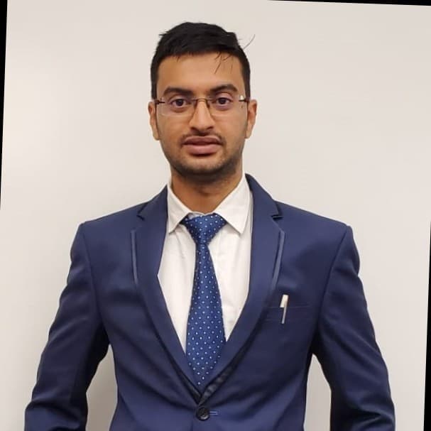 Dev, founder of Harmony Angels Home Care, in a navy suit